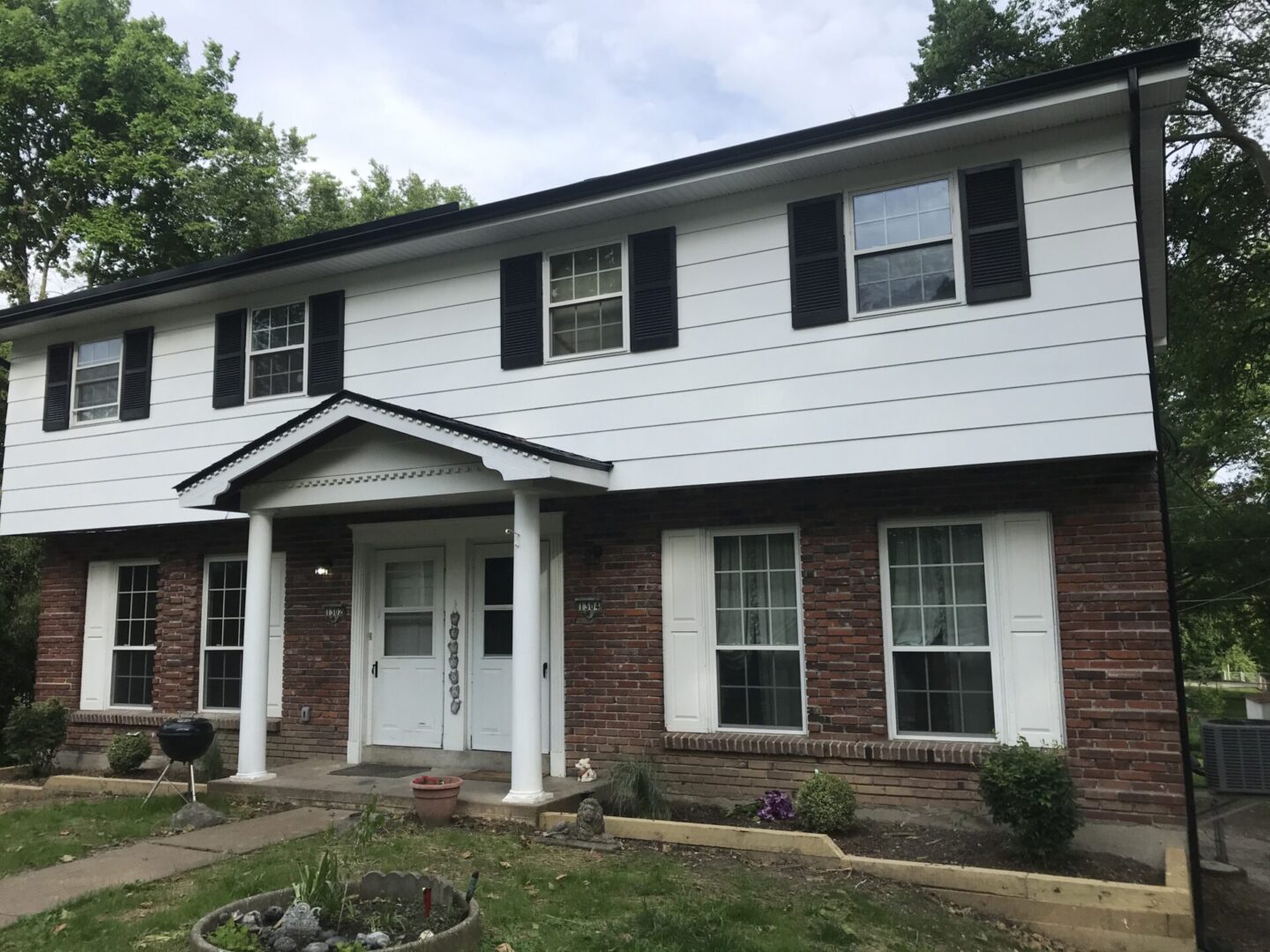 A house with black shutters and white trim.
